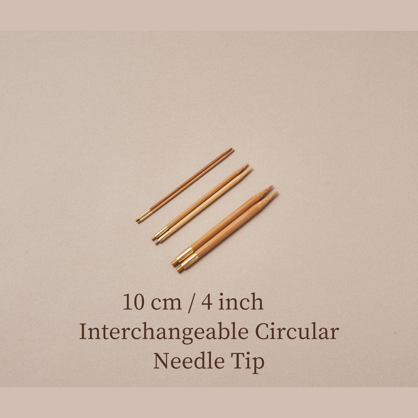 Set van drie Seeknit verwisselbare bamboe breinaaldpunten van 10 cm met messing schroefverbinding. De naaldpunten liggen op een beige achtergrond met de tekst “10 cm / 4 inch Interchangeable Circular Needle Tip” in beeld.
